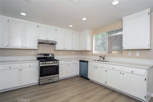 44124 Sundance Ct, Lancaster, CA 93535 - kitchen with gas range, dishwashing machine, under cabinet range hood, a sink, and white cabinets