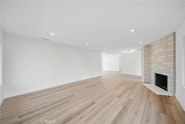 830 Huerta Verde Rd, Glendora, CA 91741 - unfurnished living room with a stone fireplace, light wood-style floors, recessed lighting, baseboards, and a chandelier