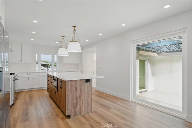 830 Huerta Verde Rd, Glendora, CA 91741 - kitchen featuring light wood finished floors, light countertops, a center island, high end stainless steel range, and recessed lighting