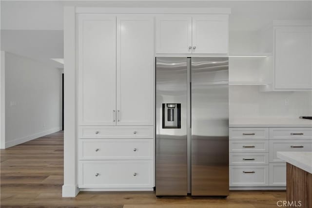 830 Huerta Verde Rd, Glendora, CA 91741 - kitchen with stainless steel fridge with ice dispenser, white cabinets, open shelves, light countertops, and wood finished floors