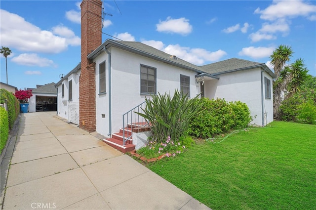 2121 Westminster Ave, Alhambra, CA 91803 - view of property exterior featuring a chimney, a lawn, and stucco siding