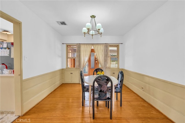 2121 Westminster Ave, Alhambra, CA 91803 - dining room with a chandelier, wainscoting, and light wood finished floors