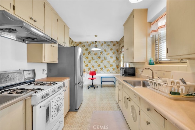 2121 Westminster Ave, Alhambra, CA 91803 - kitchen with white range with gas stovetop, wallpapered walls, under cabinet range hood, a sink, and black microwave