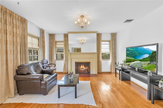 2121 Westminster Ave, Alhambra, CA 91803 - living area featuring a chandelier, healthy amount of natural light, wood finished floors, and a brick fireplace