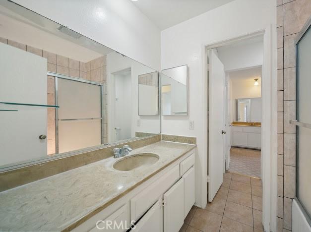 4177 Walnut Grove Ave, Rosemead, CA 91770 - bathroom featuring tile patterned flooring, vanity, and a shower with shower door