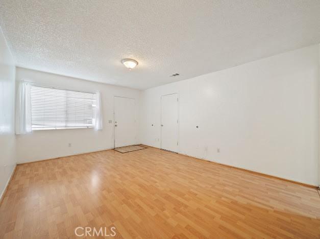 4177 Walnut Grove Ave, Rosemead, CA 91770 - spare room featuring light wood-type flooring and a textured ceiling