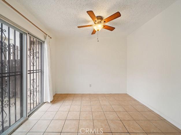 4177 Walnut Grove Ave, Rosemead, CA 91770 - spare room with a textured ceiling, ceiling fan, baseboards, and light tile patterned floors