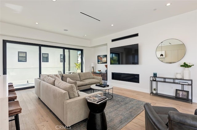 622 1st Pl, Hermosa Beach, CA 90254 - living room with light wood finished floors, recessed lighting, a glass covered fireplace, and baseboards