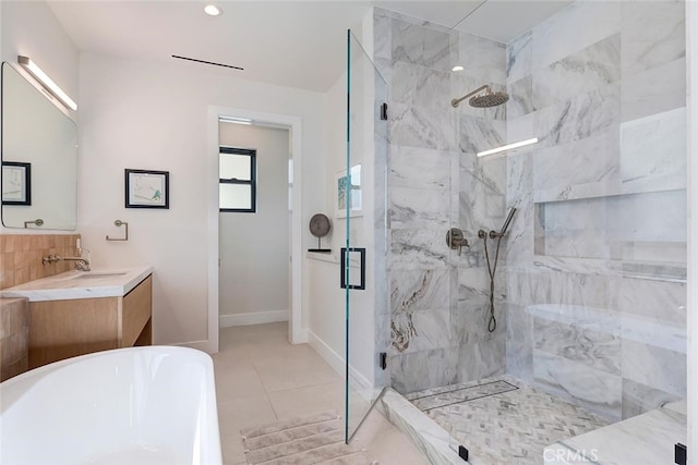 622 1st Pl, Hermosa Beach, CA 90254 - bathroom featuring a marble finish shower, a freestanding tub, vanity, baseboards, and backsplash