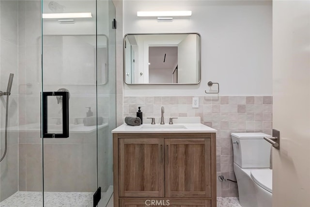 622 1st Pl, Hermosa Beach, CA 90254 - full bath with tile walls, vanity, a shower stall, toilet, and a wainscoted wall