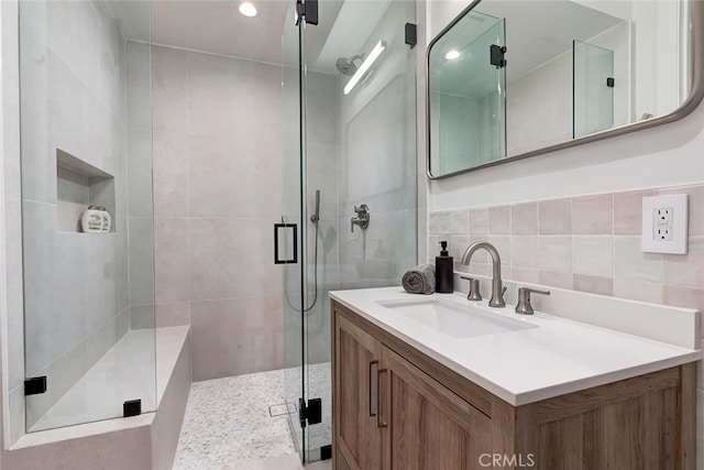 622 1st Pl, Hermosa Beach, CA 90254 - bathroom featuring a stall shower, vanity, and tile walls
