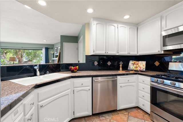 1425 E 2nd St Unit 101, Long Beach, CA 90802 - kitchen with stainless steel appliances, backsplash, white cabinetry, light stone finish flooring, and recessed lighting