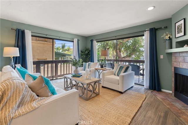 1425 E 2nd St Unit 101, Long Beach, CA 90802 - living area with a fireplace with flush hearth, wood finished floors, and recessed lighting