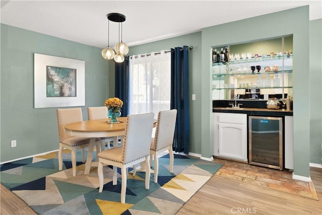 1425 E 2nd St Unit 101, Long Beach, CA 90802 - dining area with wine cooler, light wood-style flooring, and bar area
