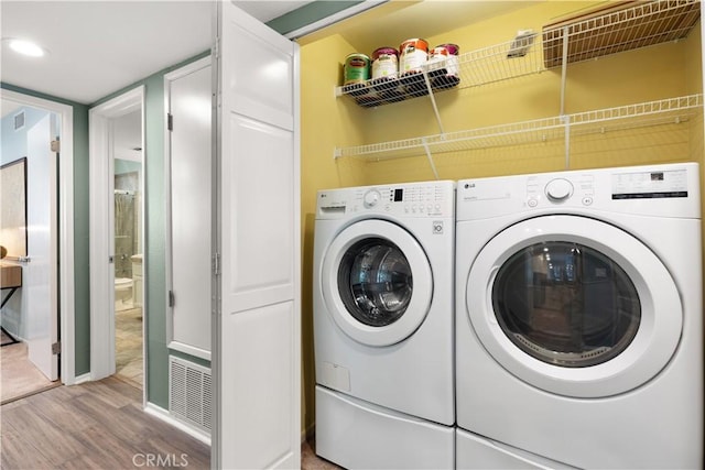 1425 E 2nd St Unit 101, Long Beach, CA 90802 - washroom featuring wood finished floors and washer and dryer
