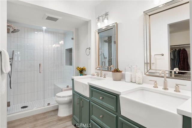 1425 E 2nd St Unit 101, Long Beach, CA 90802 - bathroom featuring double vanity, a stall shower, wood finished floors, and a spacious closet