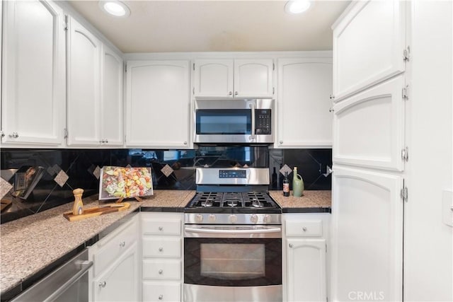 1425 E 2nd St Unit 101, Long Beach, CA 90802 - kitchen with appliances with stainless steel finishes, white cabinetry, backsplash, recessed lighting, and light countertops