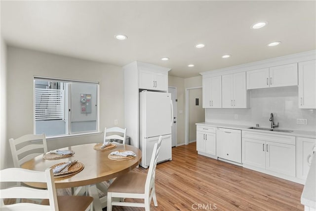 480 Mindoro St, Morro Bay, CA 93442 - kitchen featuring white appliances, a sink, light countertops, white cabinets, and light wood-style floors
