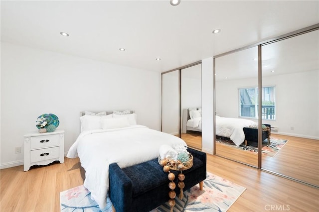 1117 Sepulveda Blvd Unit 2-102, Torrance, CA 90502 - bedroom with two closets, light wood-style flooring, recessed lighting, and baseboards