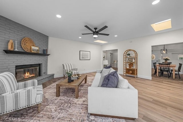 20512 Wayne Ave, Torrance, CA 90503 - living area featuring a brick fireplace, wood finished floors, recessed lighting, a ceiling fan, and a skylight