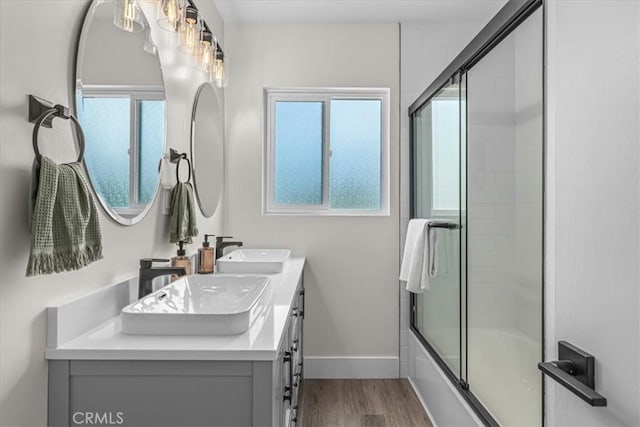 20512 Wayne Ave, Torrance, CA 90503 - full bathroom featuring wood finished floors, bath / shower combo with glass door, double vanity, and baseboards