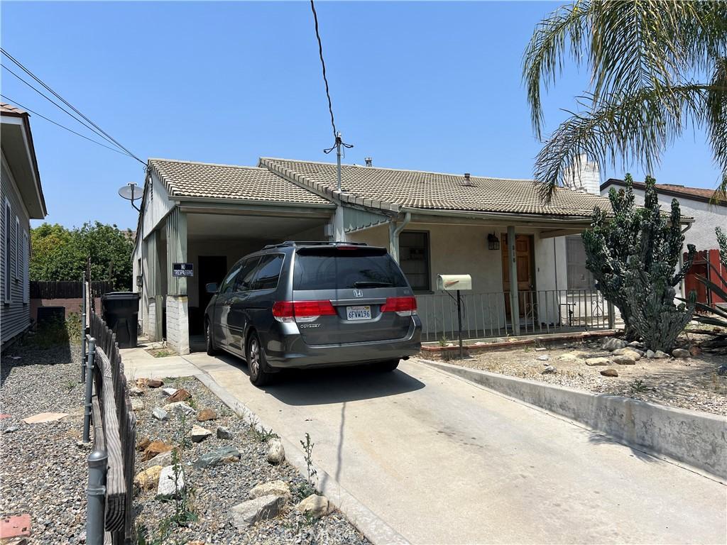 316 W Lugonia Ave, Redlands, CA 92374 - ranch-style house featuring a tiled roof, concrete driveway, and stucco siding
