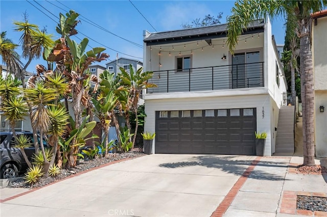 1637 Spreckels Ln, Redondo Beach, CA 90278 - view of front of property with a balcony, an attached garage, concrete driveway, and stucco siding
