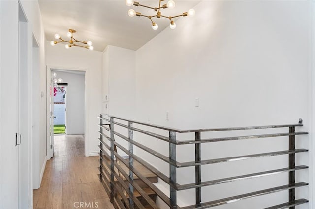 1637 Spreckels Ln, Redondo Beach, CA 90278 - hallway featuring a chandelier, light wood-style flooring, lofted ceiling, and baseboards