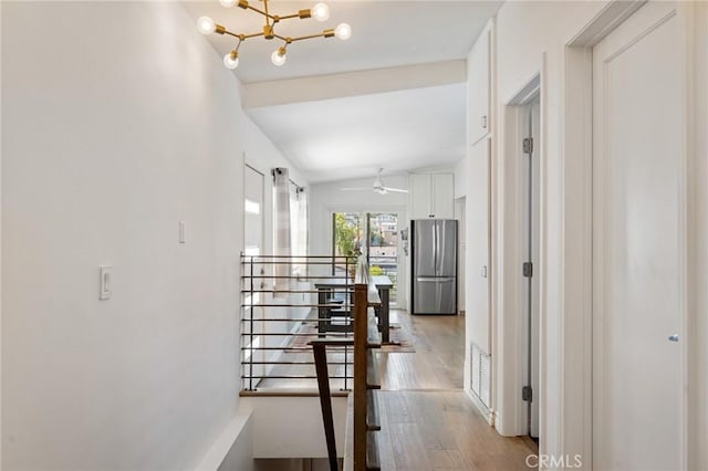 1637 Spreckels Ln, Redondo Beach, CA 90278 - hall with light wood-style floors, a chandelier, vaulted ceiling, and an upstairs landing