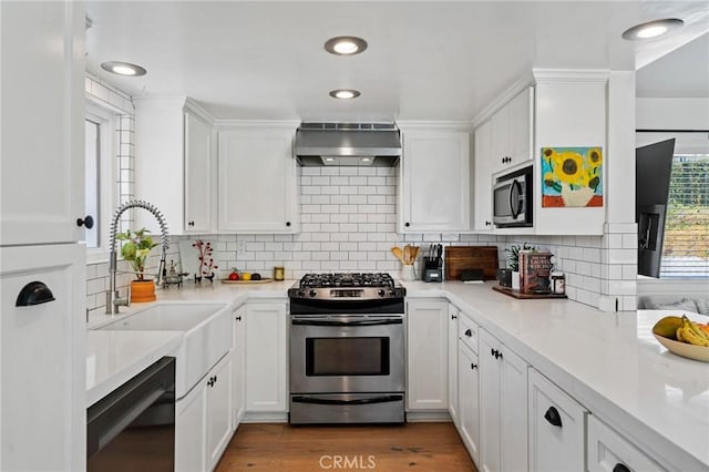 1637 Spreckels Ln, Redondo Beach, CA 90278 - kitchen with stainless steel appliances, wall chimney exhaust hood, white cabinets, a sink, and tasteful backsplash