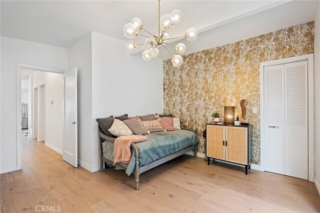 1637 Spreckels Ln, Redondo Beach, CA 90278 - bedroom with wood finished floors, baseboards, a chandelier, wallpapered walls, and an accent wall