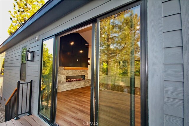 26603 Windward Rd, Lake Arrowhead, CA 92352 - doorway with wood finished floors and a fireplace
