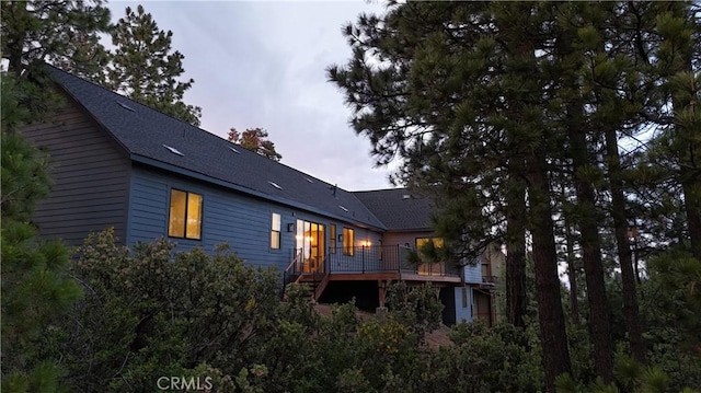26603 Windward Rd, Lake Arrowhead, CA 92352 - rear view of house with a shingled roof, a wooden deck, and stairway