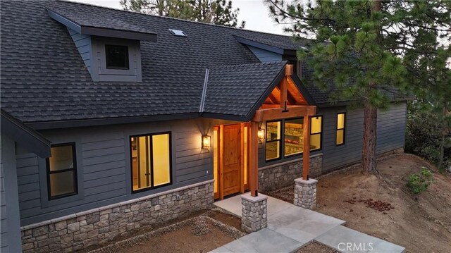 26603 Windward Rd, Lake Arrowhead, CA 92352 - view of front of home featuring stone siding and a shingled roof