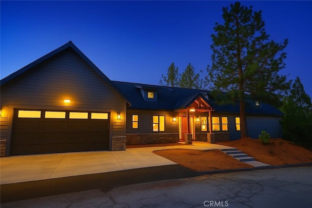 26603 Windward Rd, Lake Arrowhead, CA 92352 - view of front facade with stone siding, an attached garage, and driveway