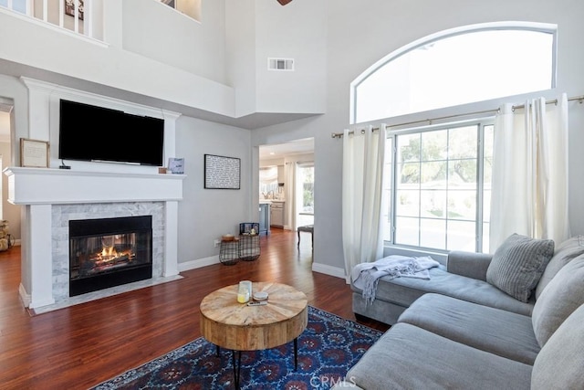 43500 Corte Barbaste, Temecula, CA 92592 - living room featuring wood finished floors, a high end fireplace, a towering ceiling, and baseboards