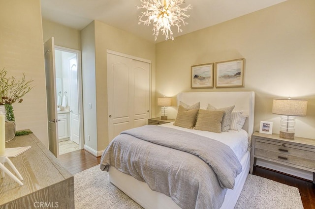 1801 Louise Ln, Nipomo, CA 93444 - bedroom featuring wood finished floors, a chandelier, a closet, connected bathroom, and baseboards