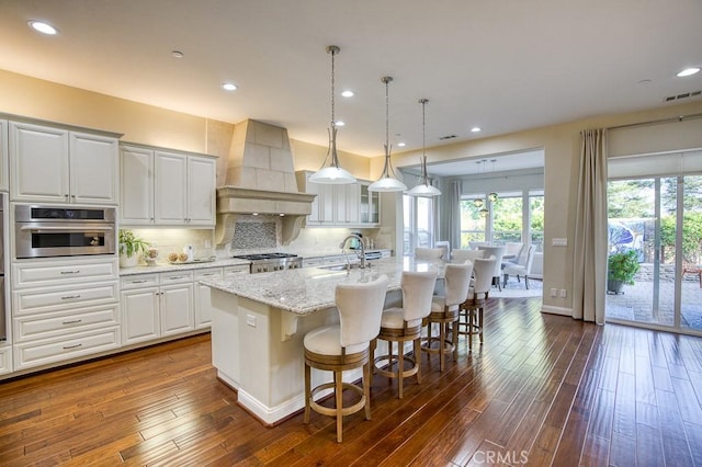 1801 Louise Ln, Nipomo, CA 93444 - kitchen with custom range hood, a sink, a kitchen island with sink, dark wood-type flooring, and recessed lighting