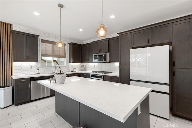 28341 Heather Green Way, Menifee, CA 92584 - kitchen featuring appliances with stainless steel finishes, dark brown cabinetry, light tile patterned floors, tasteful backsplash, and recessed lighting