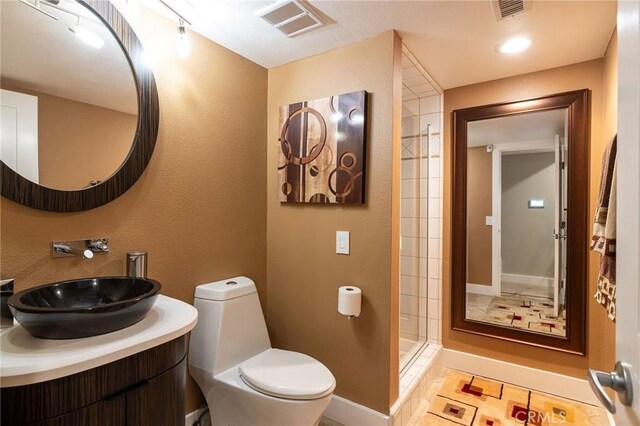 25611 Rangewood Rd, Laguna Hills, CA 92653 - bathroom featuring toilet, vanity, a shower, baseboards, and tile patterned floors