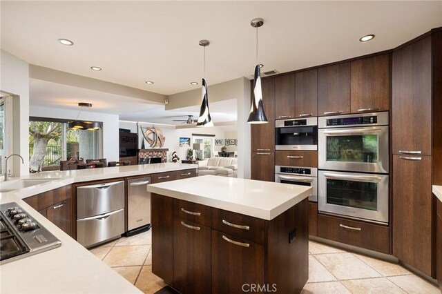 25611 Rangewood Rd, Laguna Hills, CA 92653 - kitchen featuring stainless steel appliances, a sink, a ceiling fan, light countertops, and recessed lighting