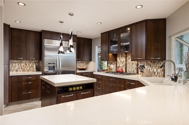 25611 Rangewood Rd, Laguna Hills, CA 92653 - kitchen featuring appliances with stainless steel finishes, a sink, light countertops, decorative backsplash, and dark brown cabinets