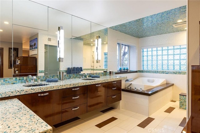 25611 Rangewood Rd, Laguna Hills, CA 92653 - full bath featuring double vanity, a garden tub, a shower stall, and tile patterned floors
