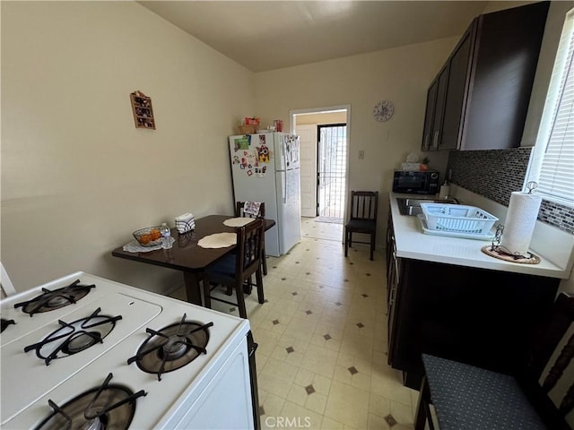 1521 Bridge St, Los Angeles, CA 90033 - kitchen featuring white appliances, light countertops, and light floors