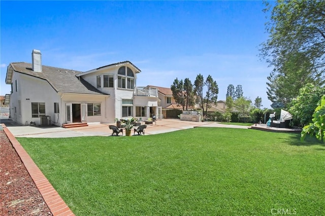 4205 Hermitage Dr, Hacienda Heights, CA 91745 - back of property featuring a balcony, stucco siding, a patio area, a lawn, and a chimney