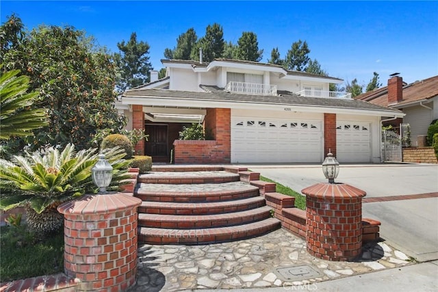 4205 Hermitage Dr, Hacienda Heights, CA 91745 - view of front of home with an attached garage, concrete driveway, brick siding, and a balcony