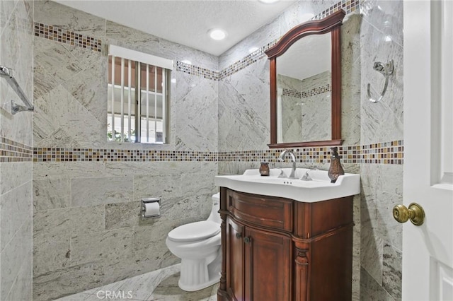 4205 Hermitage Dr, Hacienda Heights, CA 91745 - bathroom featuring vanity, tile walls, toilet, and a textured ceiling