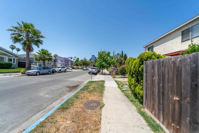 4643 Cherokee Ave, San Diego, CA 92116 - view of asphalt street with sidewalks, curbs, and a residential view