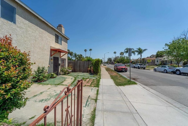 4643 Cherokee Ave, San Diego, CA 92116 - view of asphalt street with sidewalks, street lights, and curbs