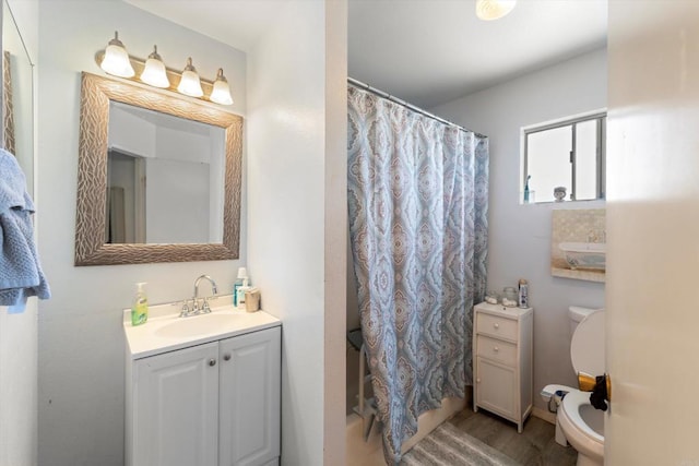 4643 Cherokee Ave, San Diego, CA 92116 - bathroom featuring toilet, vanity, and wood finished floors